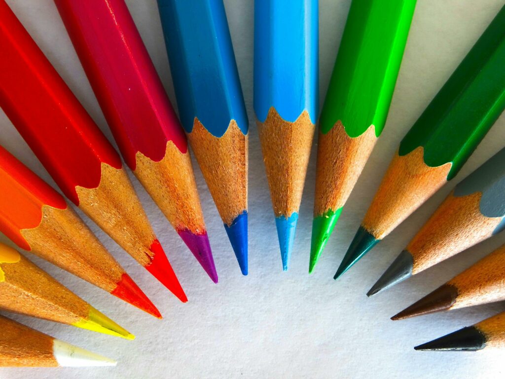 A vivid close-up of sharpened colored pencils arranged in a circular pattern.