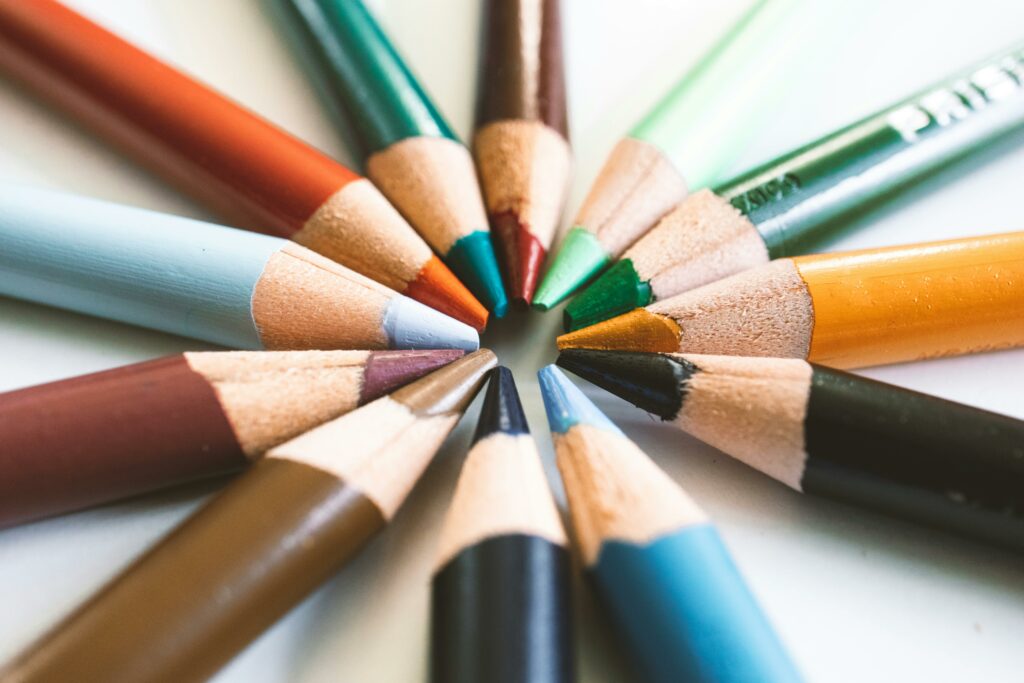 Dynamic close-up of colorful pencils arranged in a circle, perfect for creativity and art projects.
